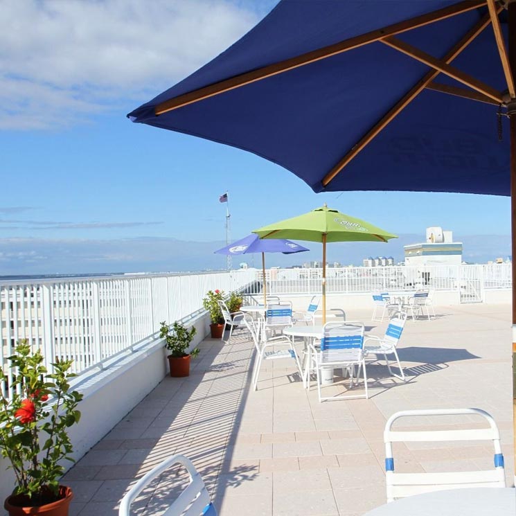 A patio with dinning chairs and tables