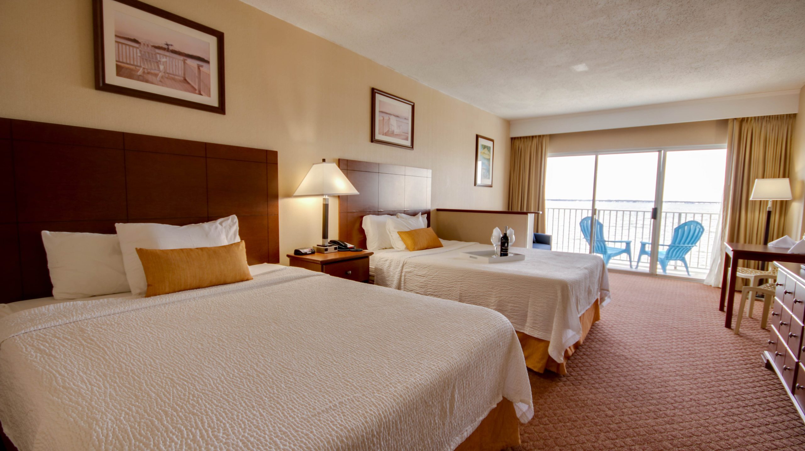 A hotel room with two double beds and a balcony